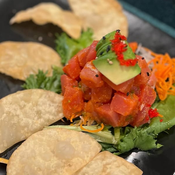 Sushi Avenue's tuna poke with avocado, roe, and sesame seeds, served with crispy wonton chips.