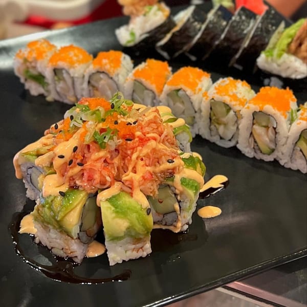 Platter of Sushi Avenue's sushi rolls, including avocado-topped and roe-covered varieties.